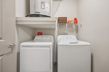 Laundry room with white dryer and washer